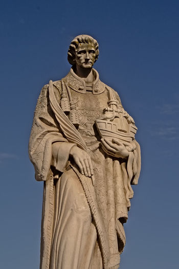 Low angle view of statue against clear blue sky