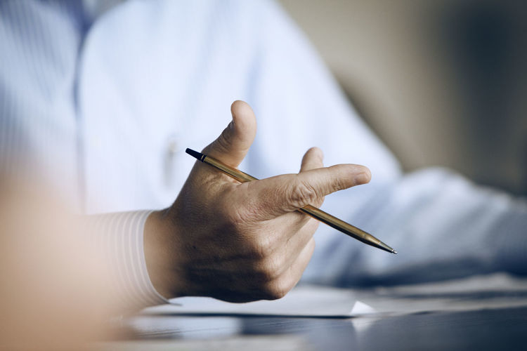 Mid-section of businessman gesturing