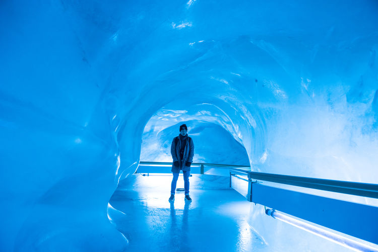 Man standing in ice cave