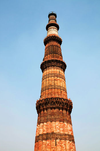Low angle view of qutub minar against clear sky