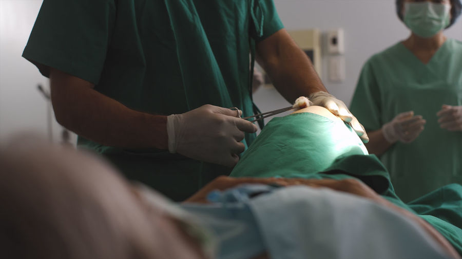 Surgeon diagnose a senior woman knee problem before a replacement surgical procedure