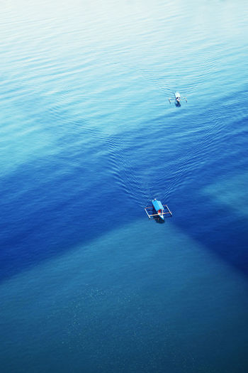 High angle view of boats on blue sea