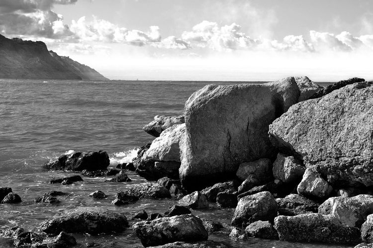 Scenic view of sea against sky black and white