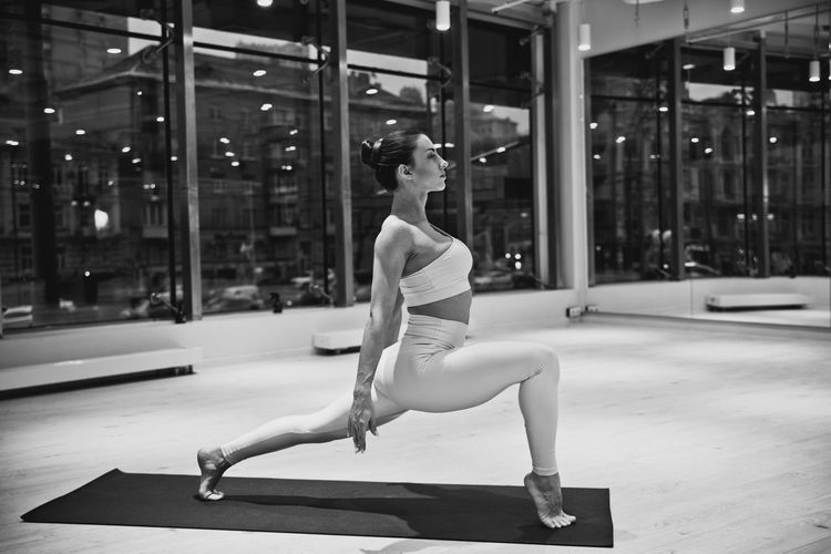 Full length of woman exercising at gym