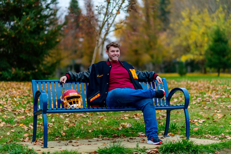 Portrait of man sitting on park bench