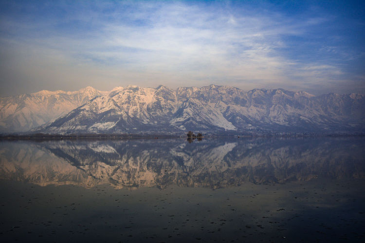 Snow covered  mountain range with reflection in the water 