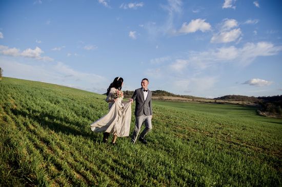 Couple kissing on field against sky