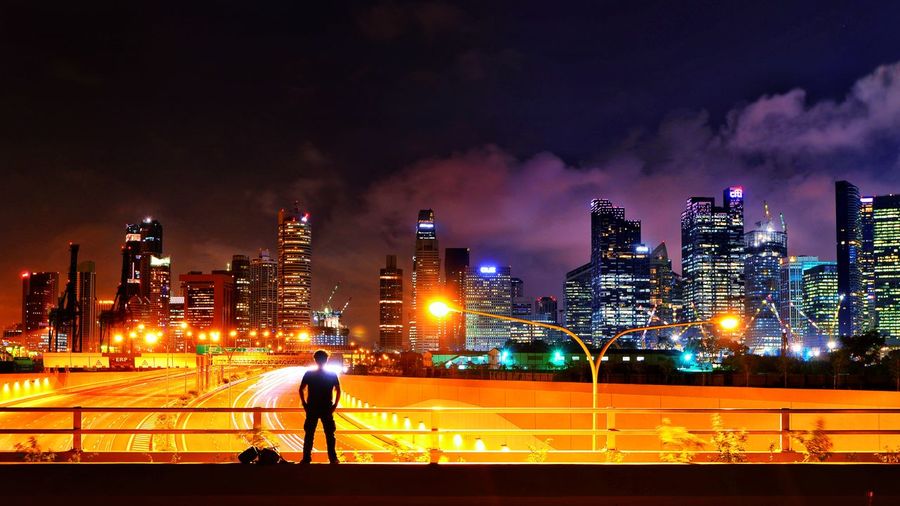 Full length of illuminated city against sky at night
