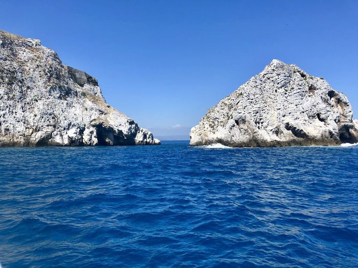 Scenic view of sea against clear blue sky