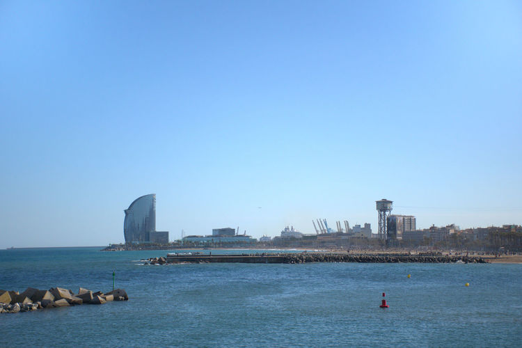 View of sea against buildings in city