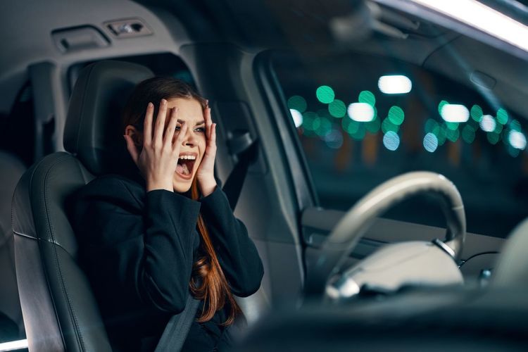 Woman screaming sitting in car