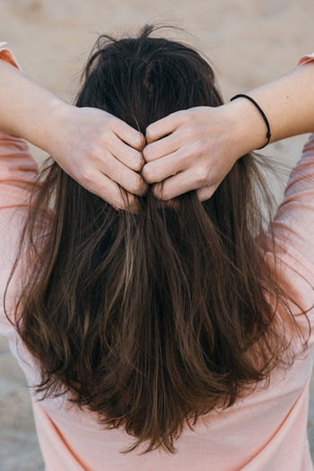 High angle view of woman hand in hair