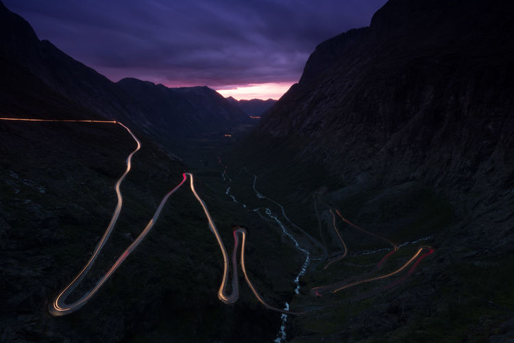 High angle view of light trail on mountain road at dusk