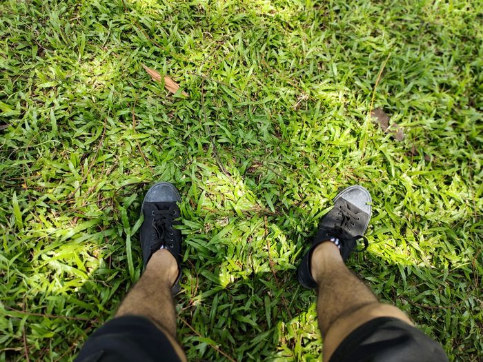 Low section of man legs on grass