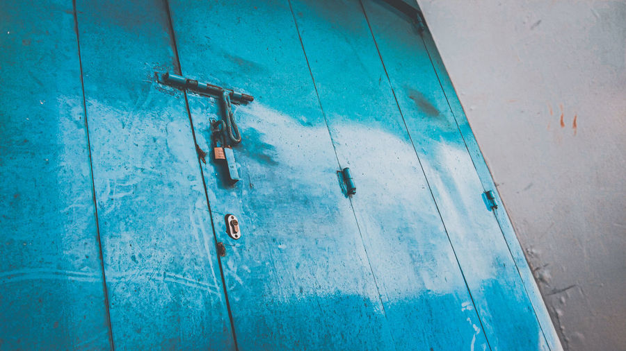 Low angle view of blue metal door