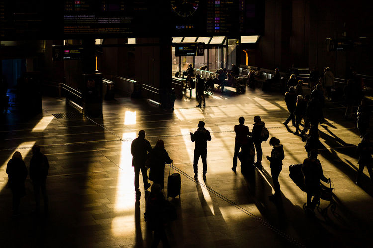 High angle view of silhouette people walking in airport