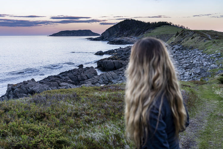 Backpacker looks out at gull island on east coast trail near bear cove