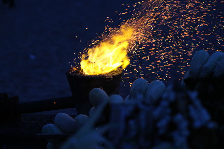 Close-up of bonfire against sky at night
