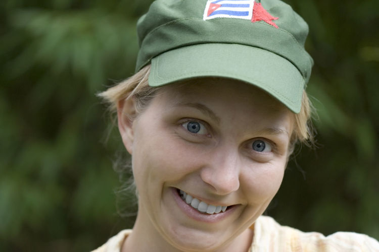 Portrait of smiling young woman wearing green cap