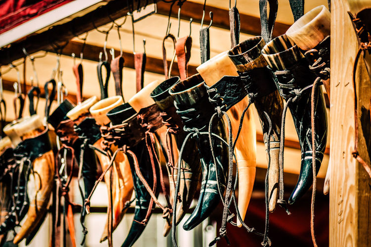 Low angle view of equipment hanging for sale at market