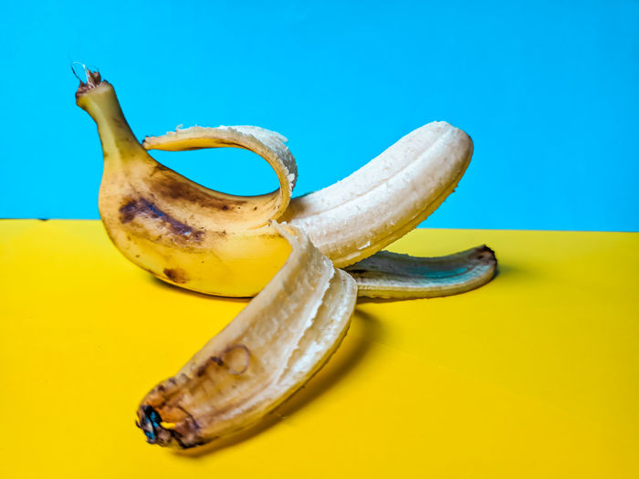 Close-up of bananas on table against blue background
