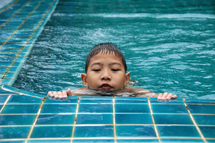 Boy swimming in pool