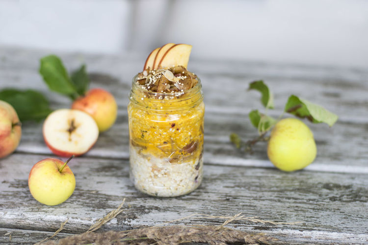 Apple porridge in jar with fruits on table 