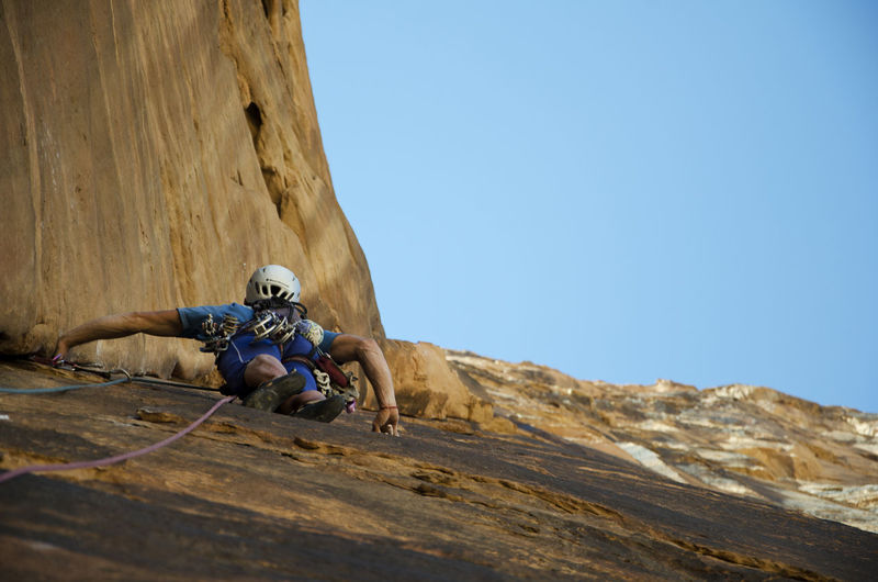 Low angle view of person rock climbing