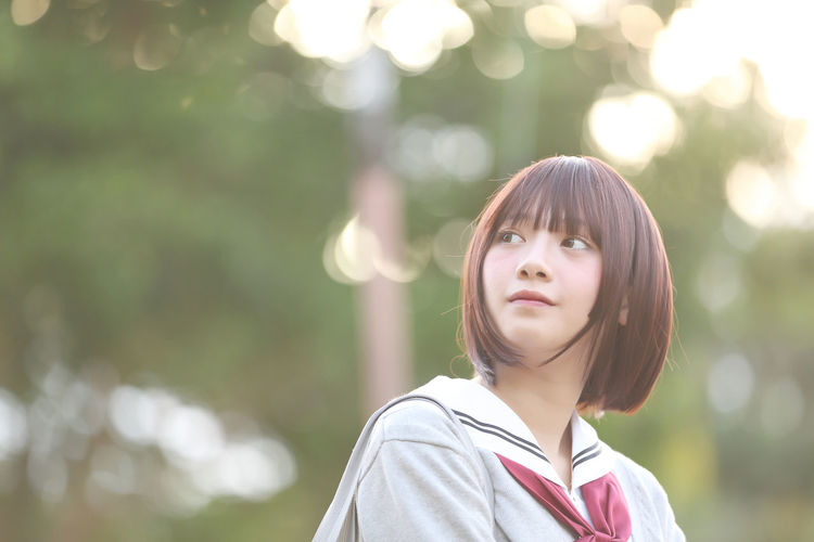 Beautiful young woman in school uniform