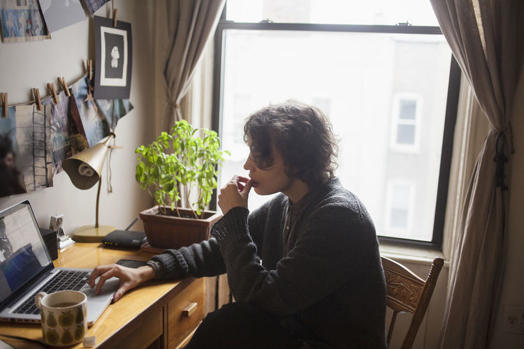 MAN SITTING ON TABLE AT HOME