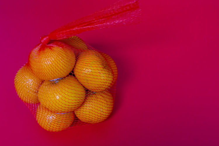Close-up of fruits against yellow background