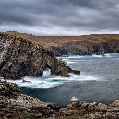 Natural sea arch near strathy point in sutherland on the north coast of scotland