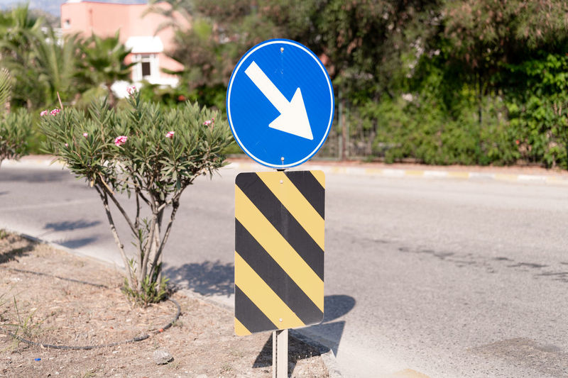 Traffic safety signs on city street road. direction movement sign outdoor. danger warning symbol