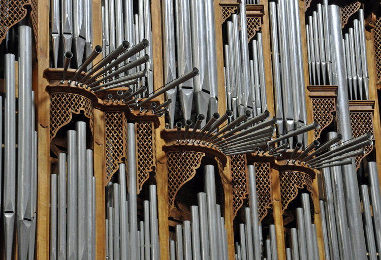 Low angle view of pipe organs in church