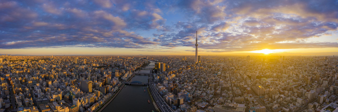 High angle view of city and buildings against sky during sunset