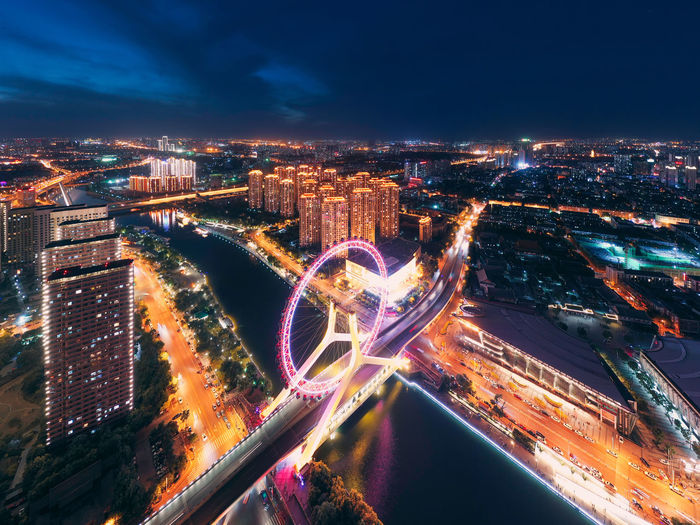 High angle view of illuminated city buildings at night