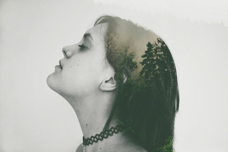 Portrait of young woman against white background