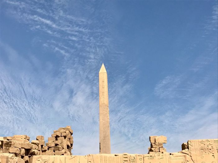Low angle view of obelisk against blue sky