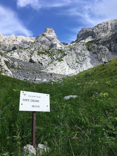 Information sign on rock against sky