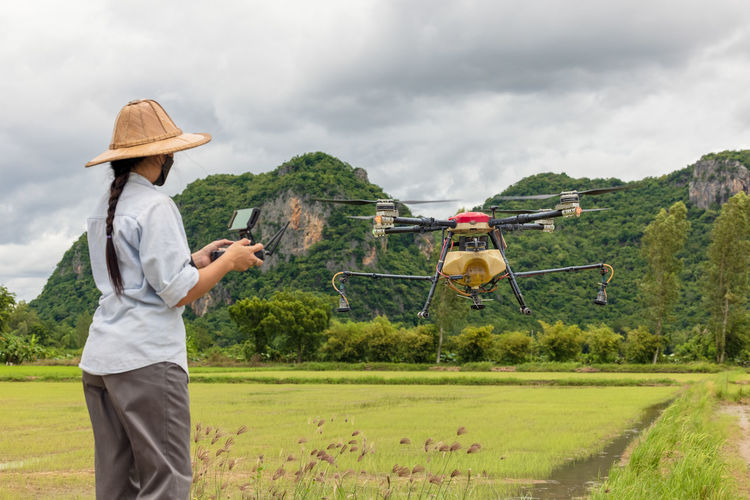 Agriculture farmer woman holds tablet to view a report on rice agriculture field