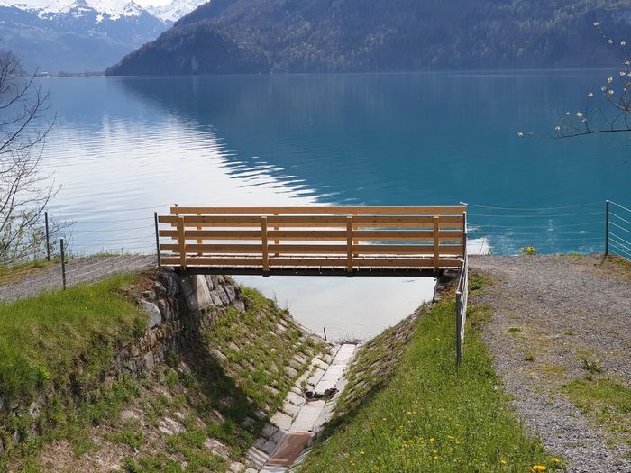 High angle view of empty bench by lake