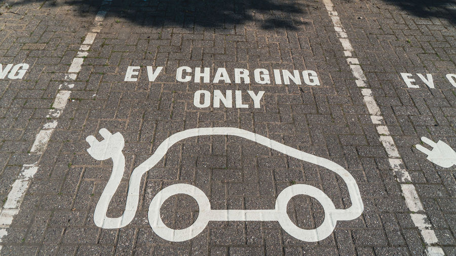 Ev charging parking space painted on car park surface