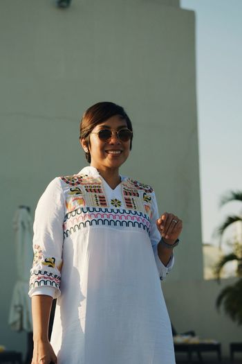Mid adult woman wearing sunglasses standing outdoors