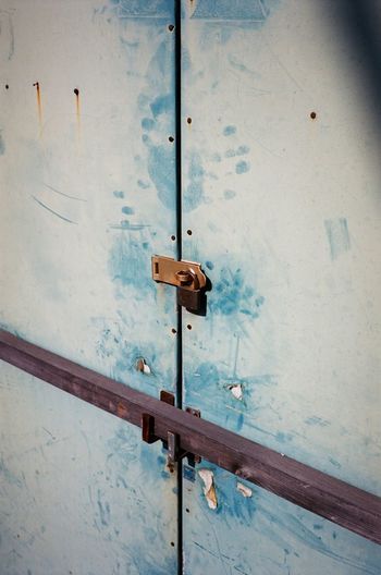 Close-up of padlocks on metal door