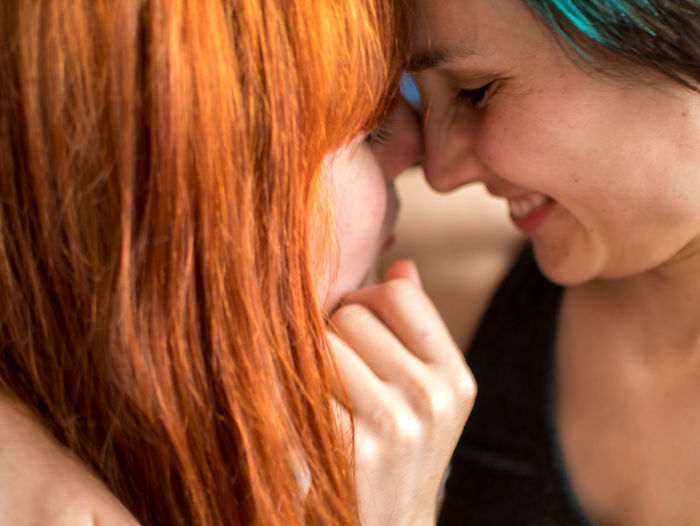 Close-up of lesbian couple face to face at home