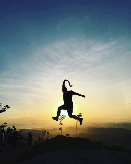 Woman jumping at sunset