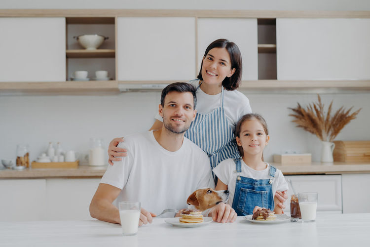 Portrait of smiling family in kitchen at home