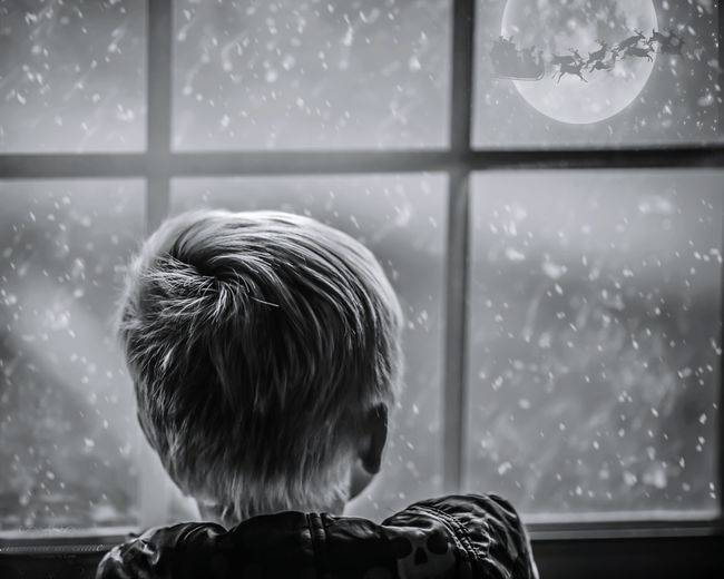 Rear view of child looking santa passing by