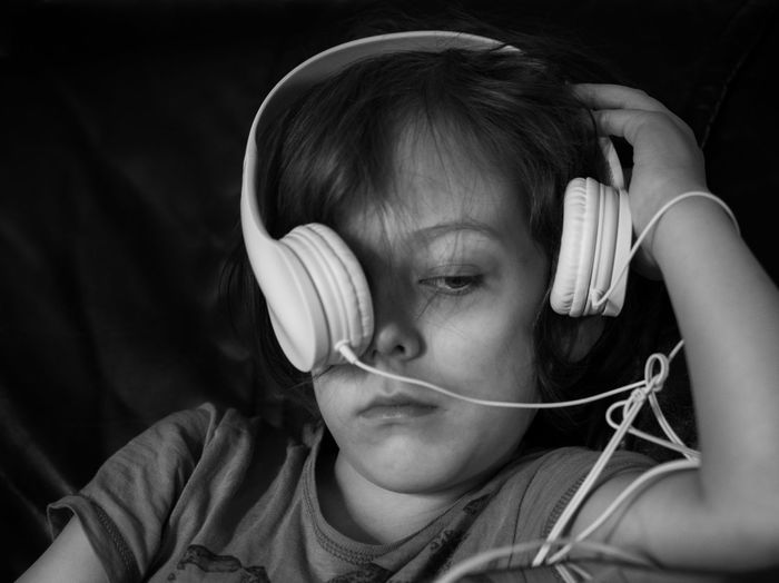 Close-up portrait of cute kid with headphones
