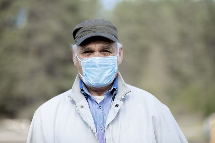 Portrait of  old man wearing a medical mask. a concept of the danger of coronavirus for the elderly.